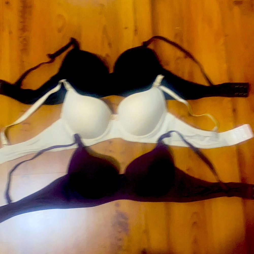 3 bras  size 36a black, beige, and dark purple.